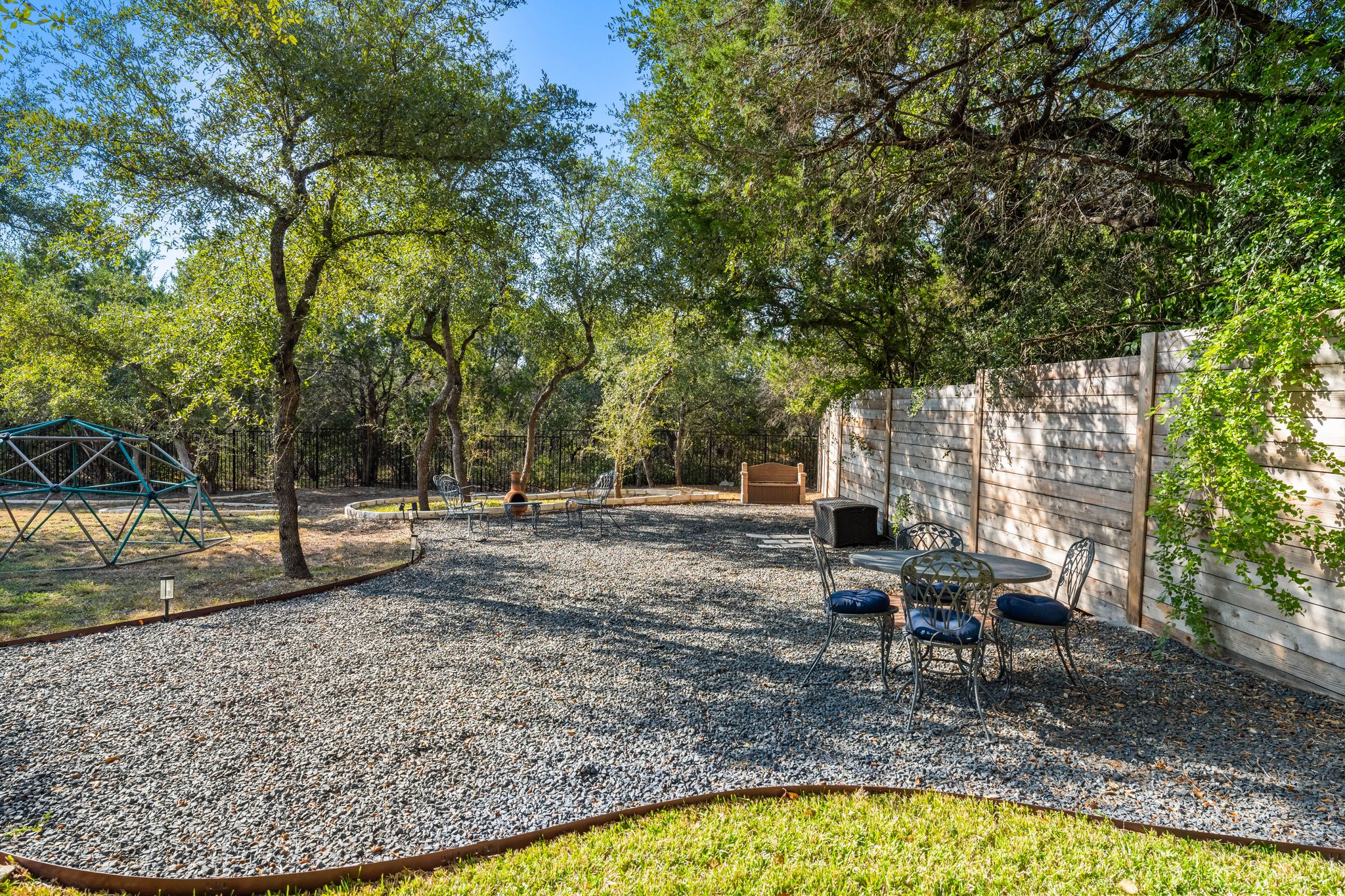 13612 Flat Top Ranch Road Austin, TX 78732 - Photo 32 of 40 a view of a backyard with sitting area