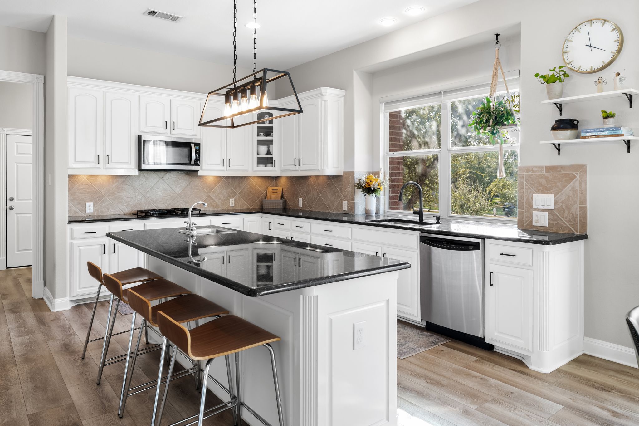13612 Flat Top Ranch Road Austin, TX 78732 - Photo 6 of 40 a kitchen with stainless steel appliances granite countertop a sink a stove a refrigerator and island