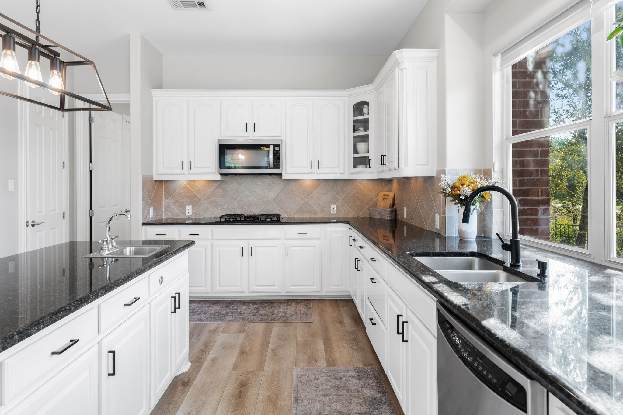 13612 Flat Top Ranch Road Austin, TX 78732 - Photo 7 of 40 a kitchen with granite countertop a sink and appliances