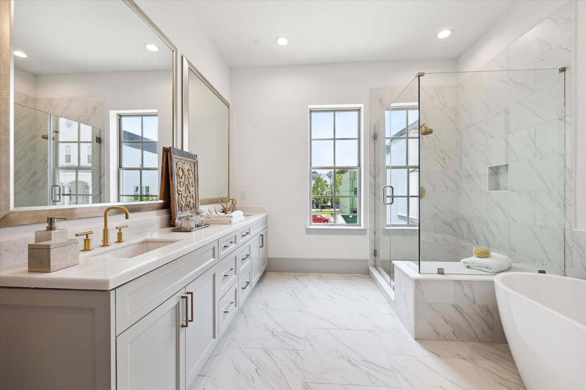 207 Sutton Row Place Houston, TX 77024 - Photo 15 of 29 Opal White Polished Marble Countertops with double sinks, soaking tub, glass walk-in shower and Carrara Matte Marble floors.