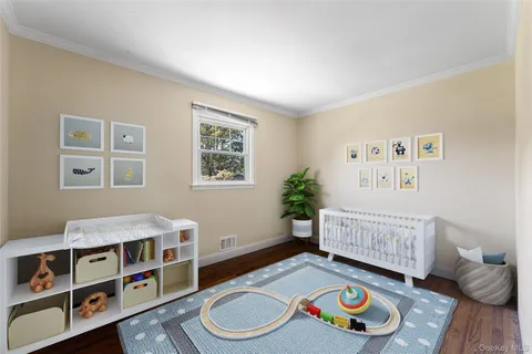 a living room with furniture and baby crib