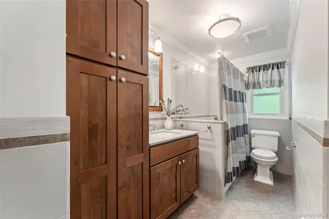 a bathroom with a toilet a sink and a mirror