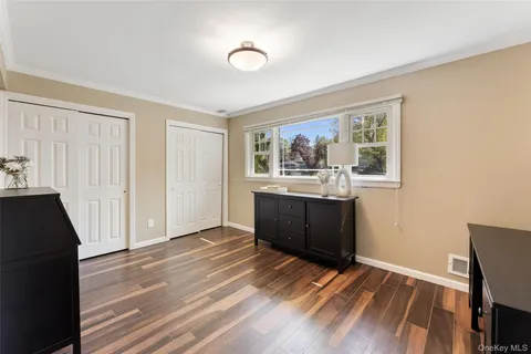 a view of a kitchen with wooden floor and a window