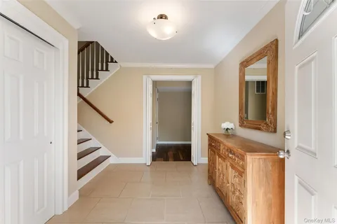 a view of hallway with stairs and furniture