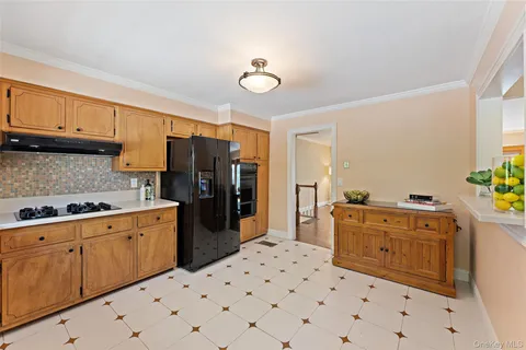 a kitchen with stainless steel appliances a stove a sink and a refrigerator