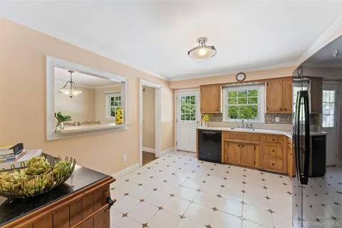 a kitchen with stainless steel appliances kitchen island granite countertop a refrigerator and a sink