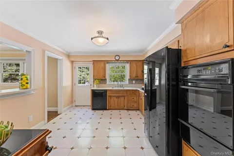 a kitchen with granite countertop a refrigerator and a stove top oven