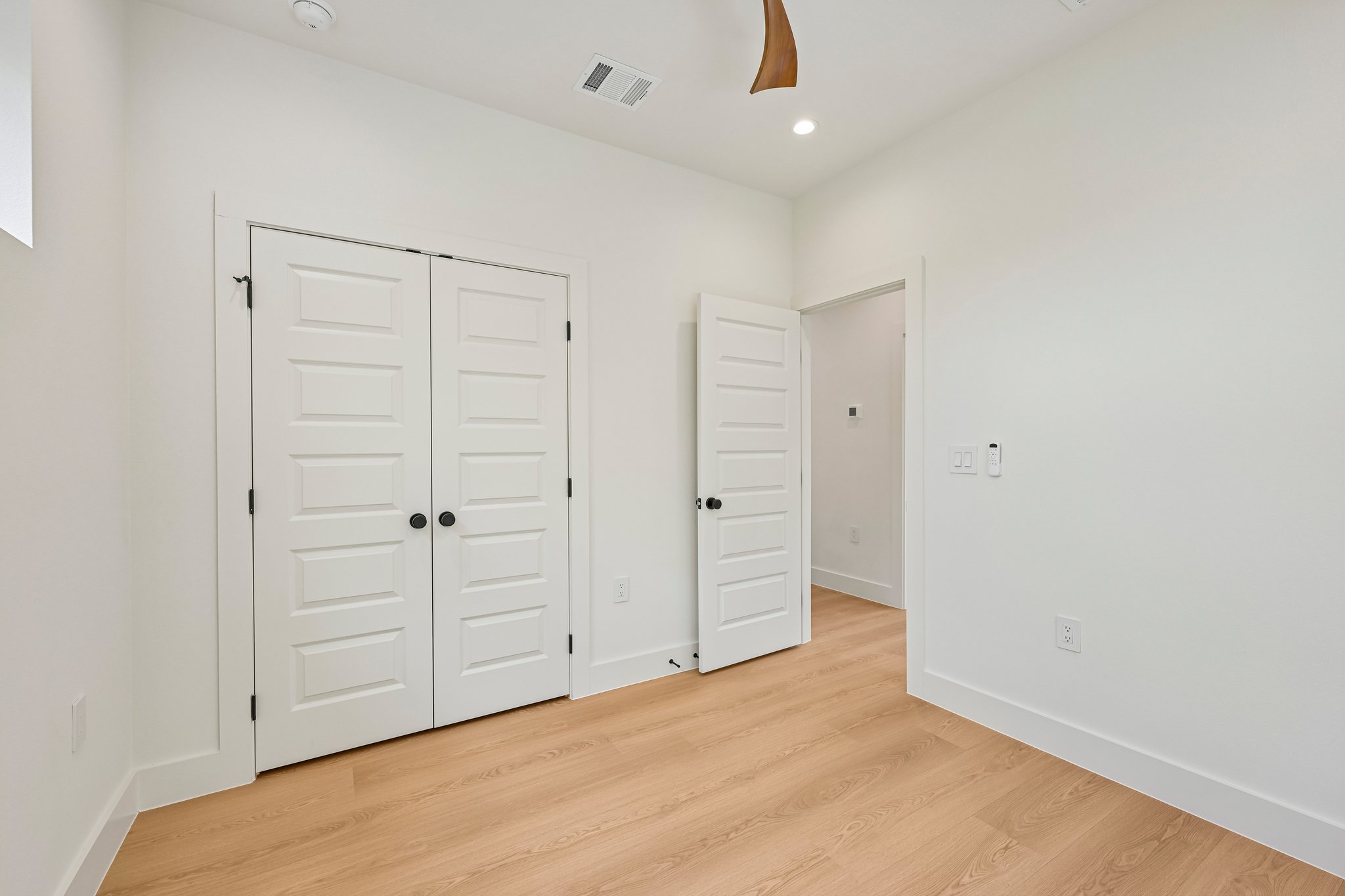 513 West Odell Street, Unit B Austin, TX 78752 - Photo 29 of 38 Blonde wood flooring and bright white walls create a serene, airy atmosphere in this versatile interior space.
