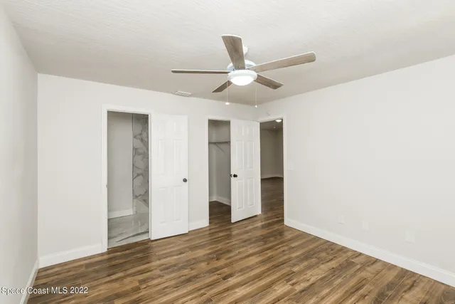a kitchen with kitchen island granite countertop a sink a stove and cabinets