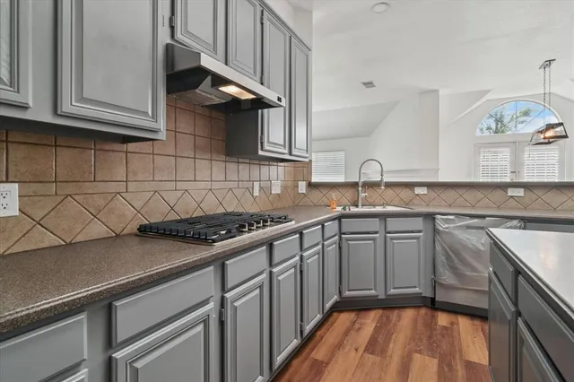 a kitchen with stainless steel appliances granite countertop a sink and cabinets