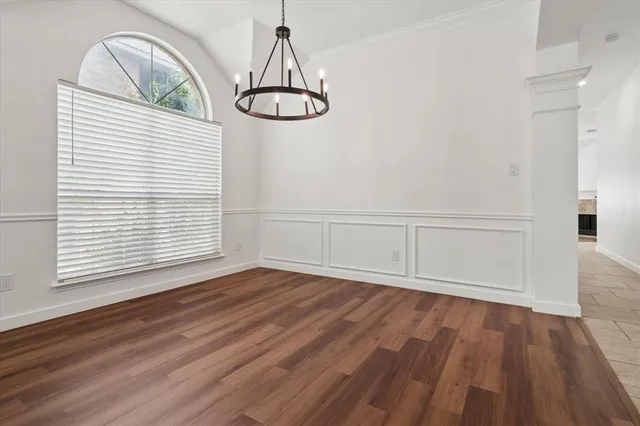 a view of a room with wooden floor and window