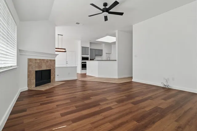 a view of a room with wooden floor and a fireplace