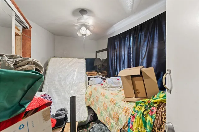 a bed sitting in a bedroom next to a window