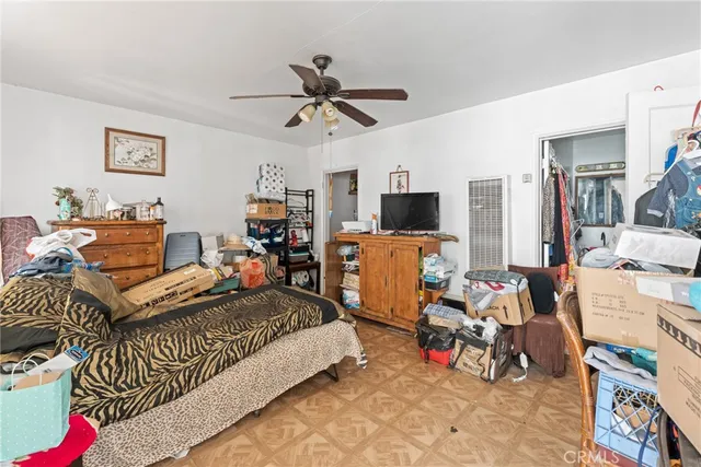 a bed room with a bed furniture and a flat screen tv