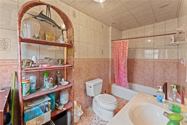 a bathroom with a toilet a sink and a shower