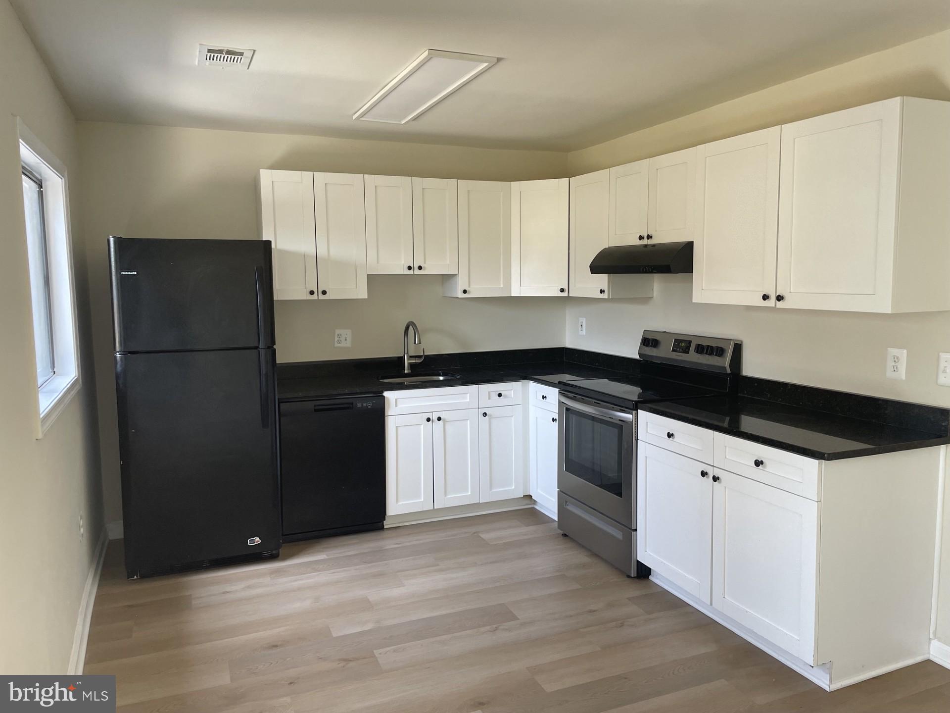 1287 Springtide Place Herndon, VA 20170 - Photo 6 of 23 a kitchen with a sink a stove and refrigerator