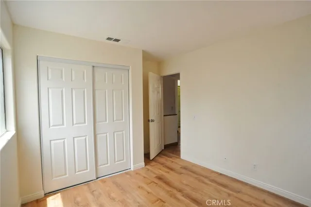 a view of an empty room with closet area