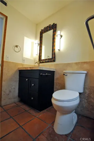 a bathroom with a sink toilet and mirror