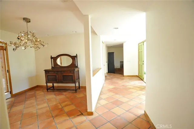 a view of a livingroom with a chair and a chandelier