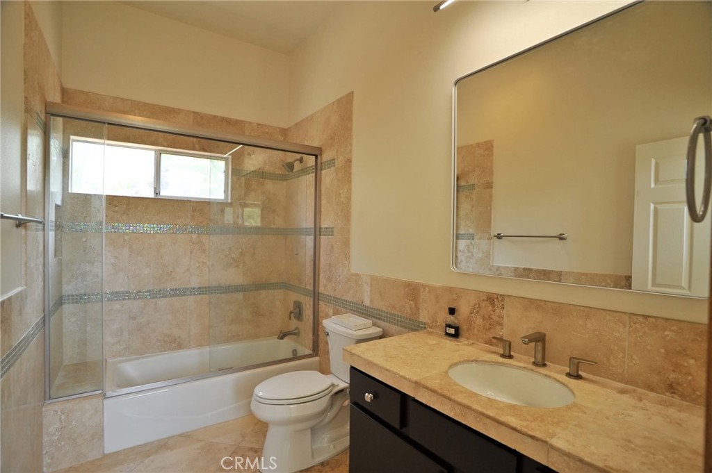 1707 Hygeia Avenue Encinitas, CA 92024 - Photo 25 of 41 a bathroom with a granite countertop sink toilet and shower