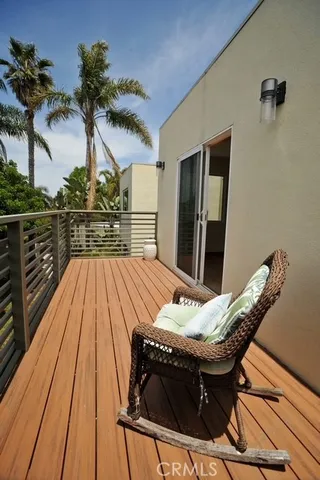 a balcony with table and chairs