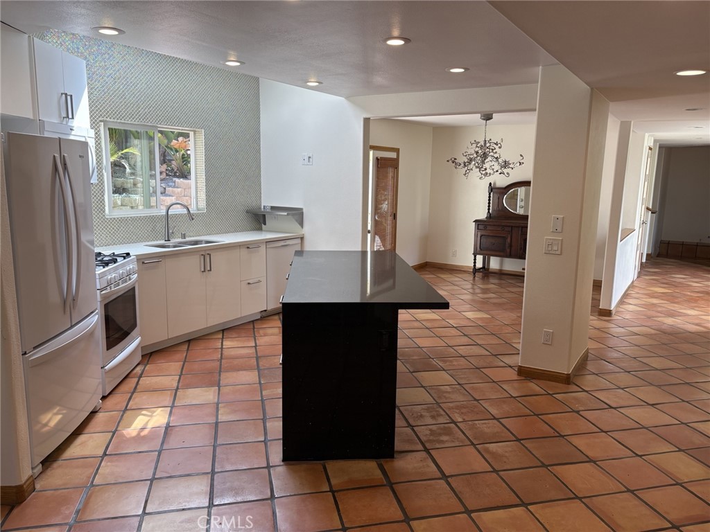 1707 Hygeia Avenue Encinitas, CA 92024 - Photo 5 of 41 a large kitchen with a counter space and wooden floor