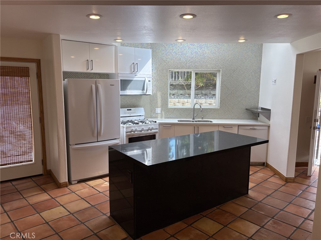 1707 Hygeia Avenue Encinitas, CA 92024 - Photo 7 of 41 a kitchen with stainless steel appliances granite countertop a refrigerator a sink and a stove
