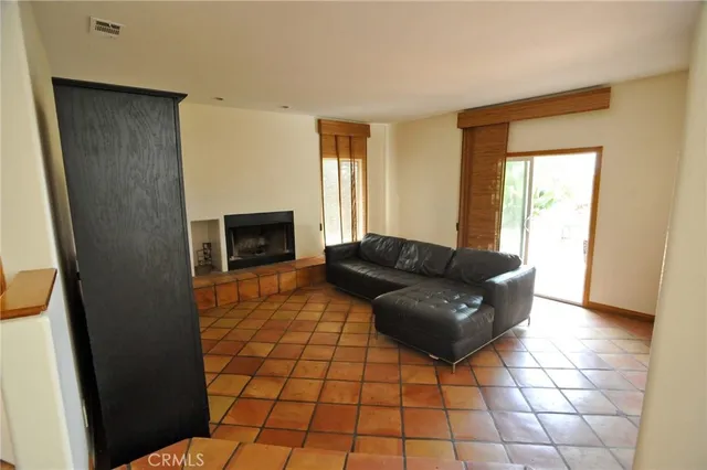 a living room with a couch and a fireplace