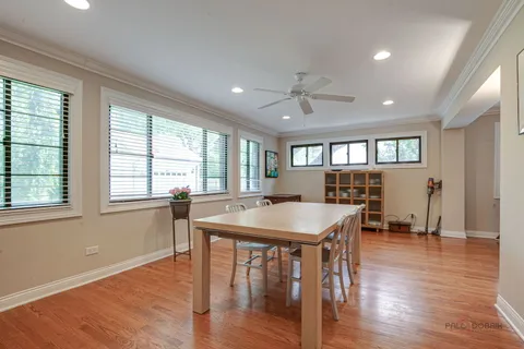 a view of a a dining room with furniture window and wooden floor