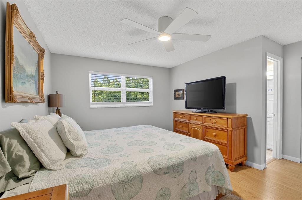 2601 Northeast 3rd Street, Unit 403 Boynton Beach, FL 33435 - Photo 11 of 33 a bedroom with a bed and a flat screen tv