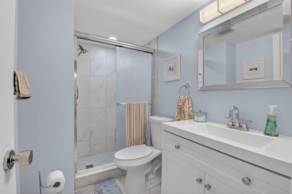 2601 Northeast 3rd Street, Unit 403 Boynton Beach, FL 33435 - Photo 16 of 33 a bathroom with a sink toilet and shower