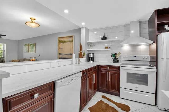 a kitchen with a sink stove and cabinets