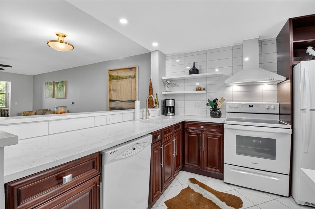 2601 Northeast 3rd Street, Unit 403 Boynton Beach, FL 33435 - Photo 6 of 33 a kitchen with a sink stove and cabinets