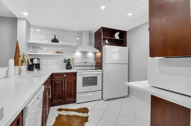 a kitchen with stainless steel appliances a refrigerator sink and cabinets