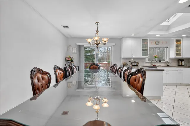 a dining room filled with furniture and chandelier