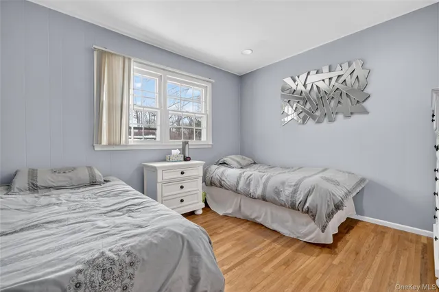 a bedroom with two beds and a window