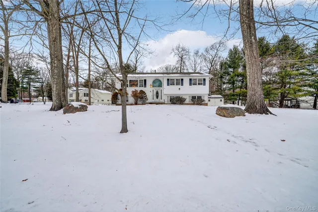 a view of a house with a yard covered in snow