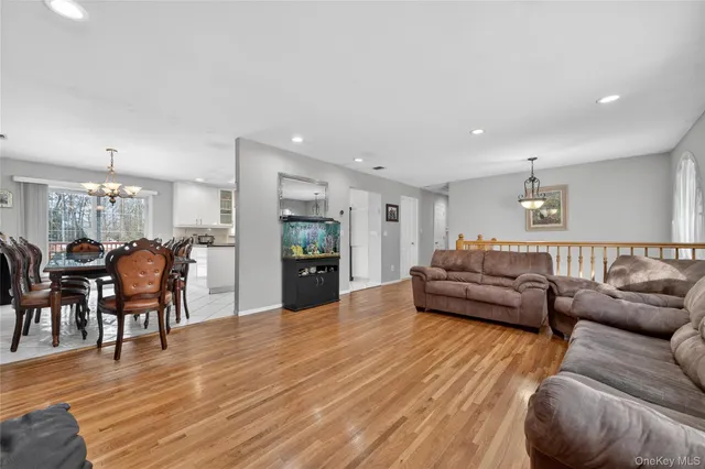 a living room with furniture and kitchen view