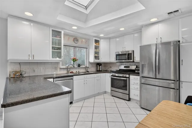 a kitchen with a sink stainless steel appliances and cabinets