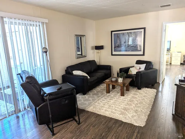 a living room with furniture rug and wooden floor