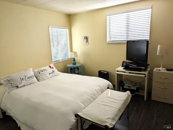 a bedroom with a bed and a flat screen tv