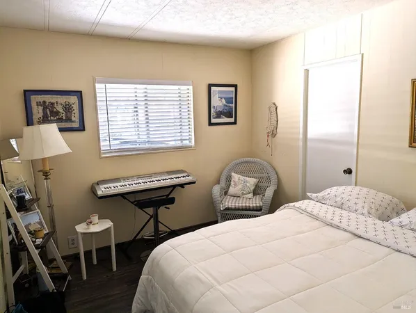 a bedroom with two beds and a desk