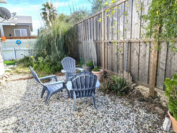 a view of a chair and table in backyard