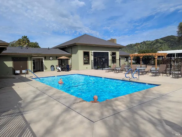 a view of a house with swimming pool and porch with furniture