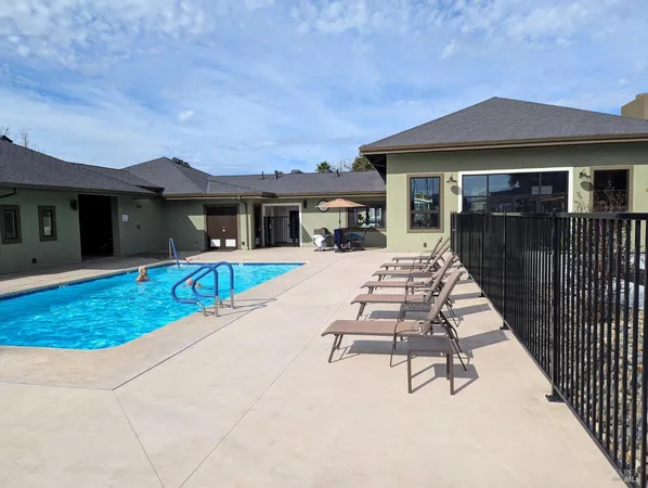 a view of a yard patio and swimming pool