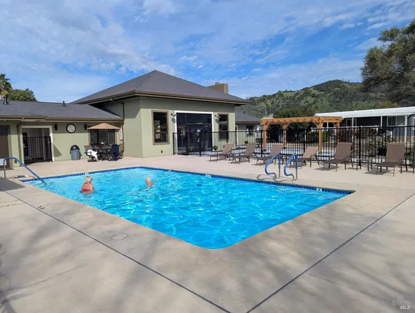 a view of a livingroom with furniture hardwood floor and a flat screen tv