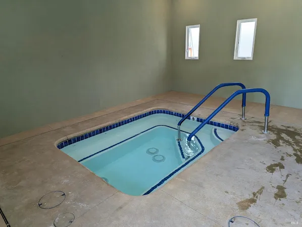 a patio with a table and chairs under an umbrella