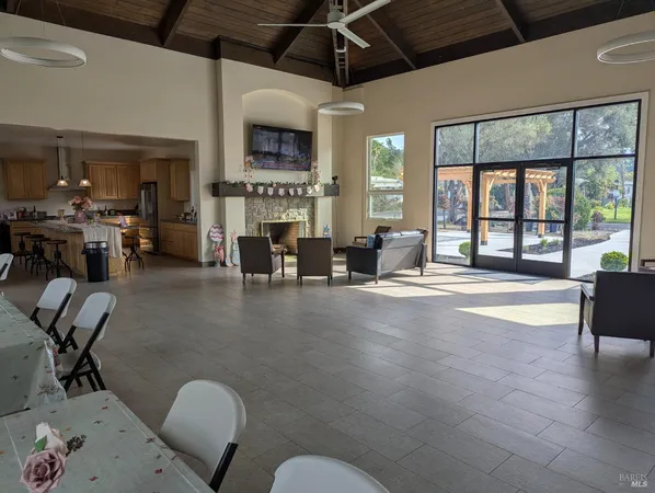 a kitchen with kitchen island a large counter top space appliances and a window