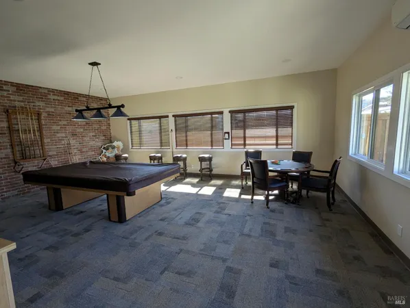 a living room with furniture gym equipment and a large window