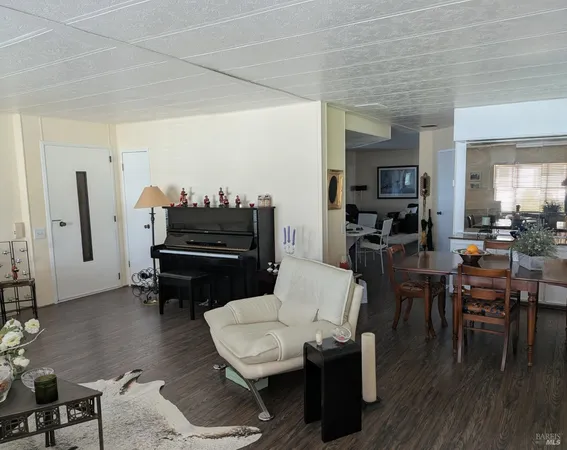 a living room with furniture and a piano